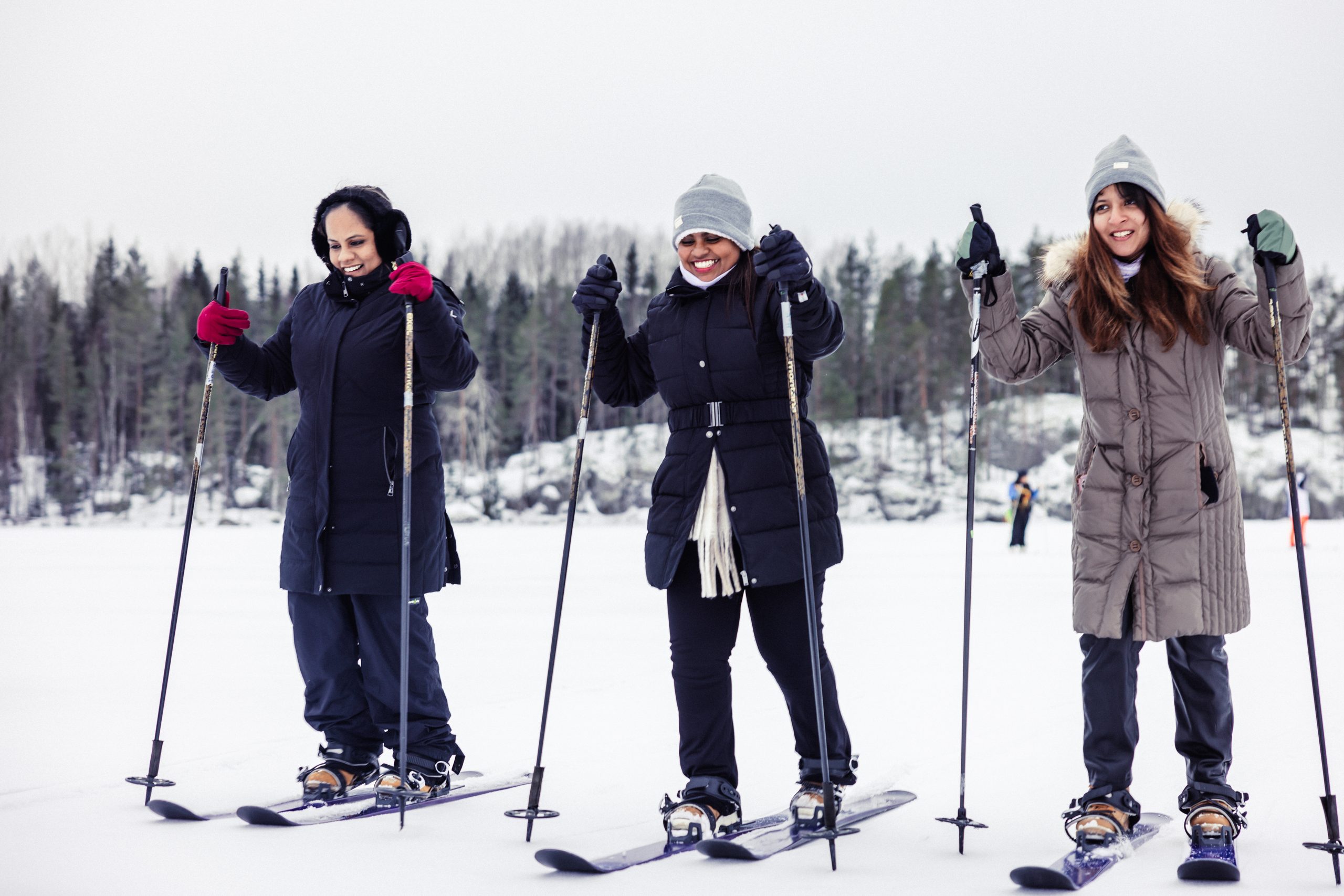Three ladies are skiing.